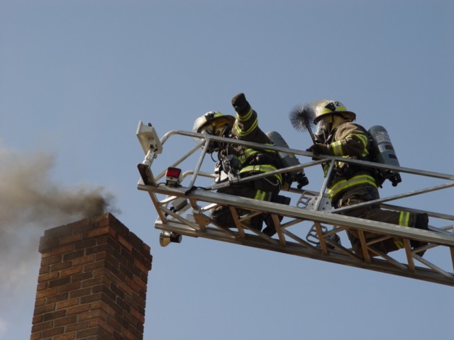 Ladder 4-2 firefighters prepare to work a chimney on Moscow Road.